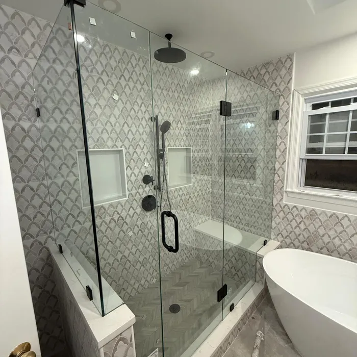 Frameless glass shower enclosure